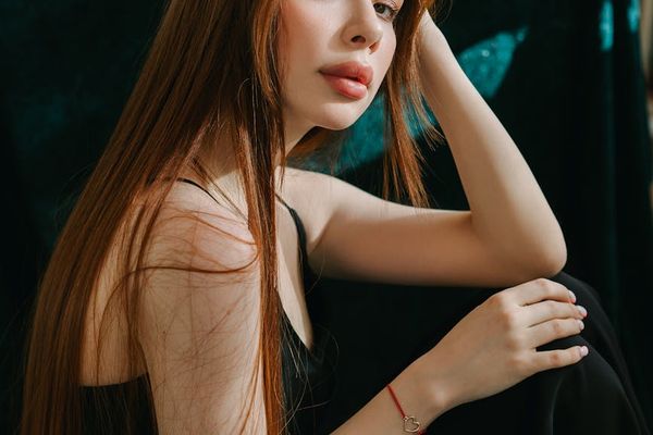 A person in a focused seated meditation pose, seen from the side.